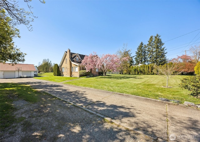 46919 244th Ave SE, Enumclaw, WA 98022 - view of property exterior featuring a garage, a yard, and a chimney