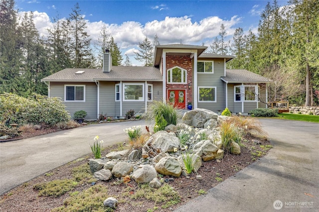 view of front of property with driveway and a chimney