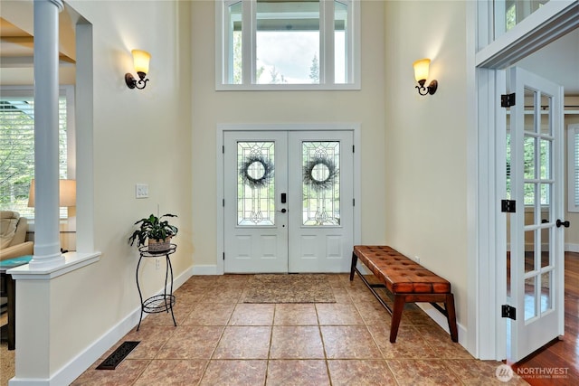 entryway with a healthy amount of sunlight, visible vents, french doors, and tile patterned flooring
