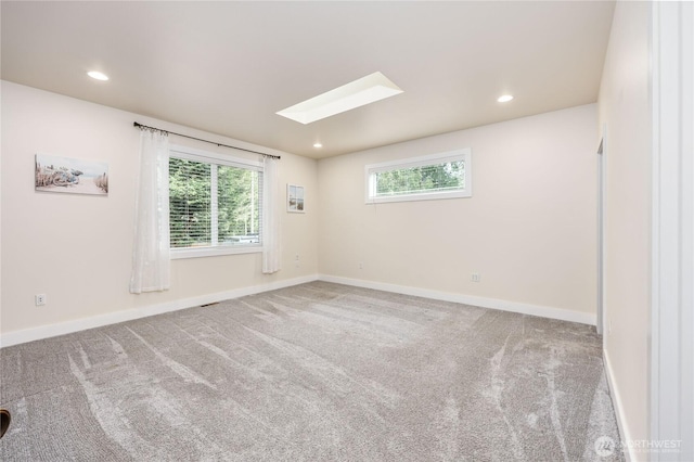 empty room featuring baseboards, carpet flooring, and a wealth of natural light