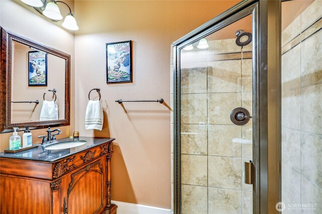 full bath with a shower stall and vanity