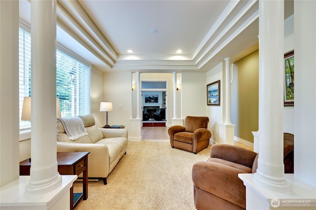 living area with a tray ceiling, recessed lighting, ornate columns, baseboards, and carpet floors