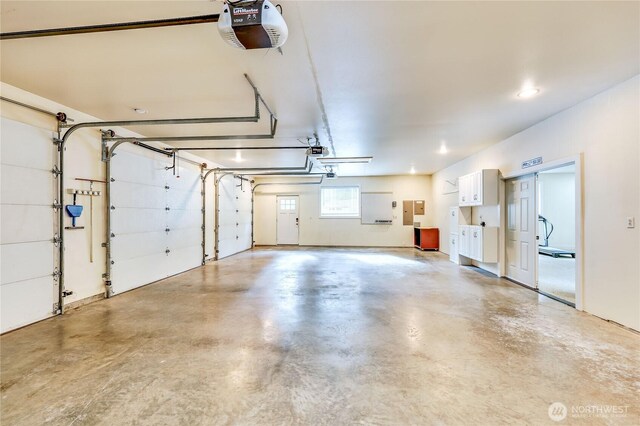 garage with electric panel and a garage door opener
