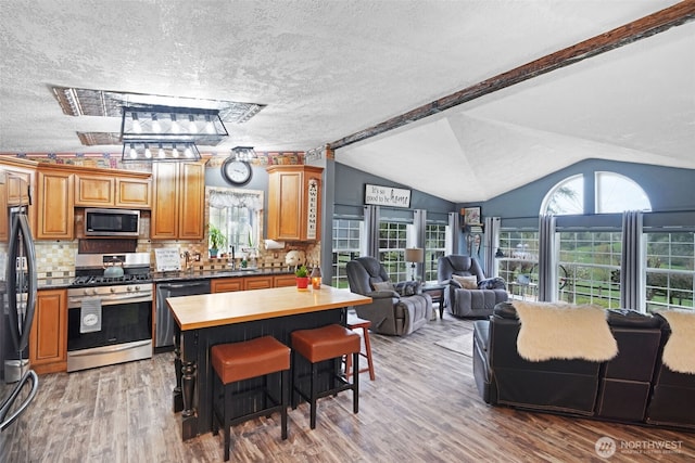 254 Macomber Rd, Chehalis, WA 98532 - kitchen featuring open floor plan, vaulted ceiling, wooden counters, and appliances with stainless steel finishes