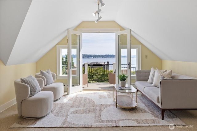 2720 W Galer St, Seattle, WA 98199 - living area with track lighting, lofted ceiling, a water view, and baseboards