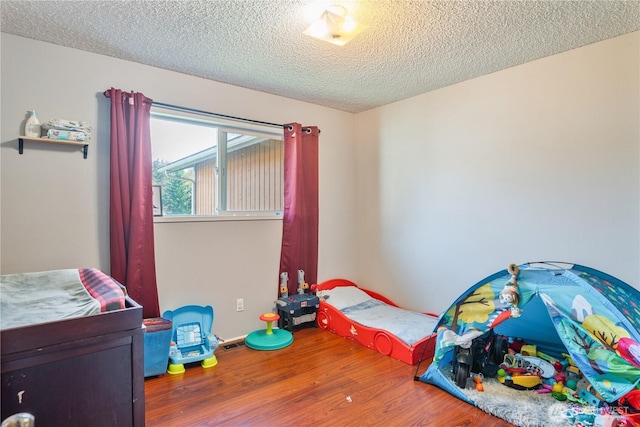 1658 N 2nd, Kelso, WA 98626 - bedroom featuring wood finished floors and a textured ceiling
