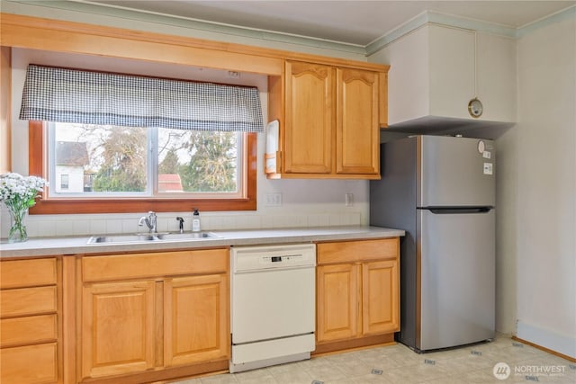 77 S Welcome Slough, Cathlamet, WA 98612 - kitchen featuring light countertops, light brown cabinets, a sink, freestanding refrigerator, and white dishwasher