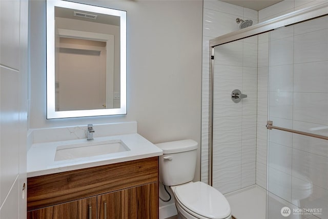 18717 68th Ave NE Unit 103, Kenmore, WA 98028 - full bathroom featuring a shower stall, vanity, visible vents, and toilet