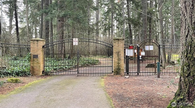 2815 Fordham Ct SE, Olympia, WA 98503 - view of gate featuring a view of trees and fence