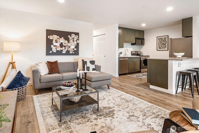 2501 Canterbury Ln E Unit 122, Seattle, WA 98112 - living room with light wood finished floors, baseboards, and recessed lighting