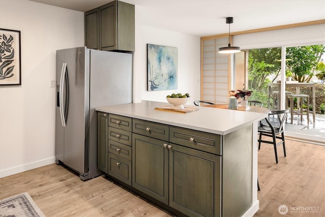 2501 Canterbury Ln E Unit 122, Seattle, WA 98112 - kitchen with light countertops, a peninsula, stainless steel fridge with ice dispenser, and light wood-type flooring