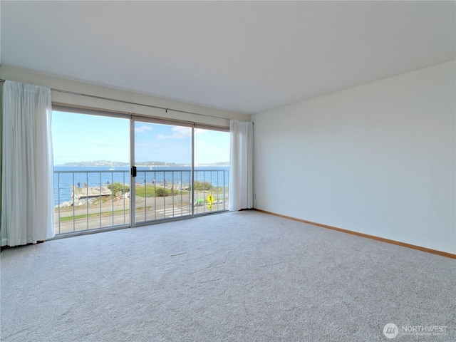 1156 Alki Ave SW Unit 204, Seattle, WA 98116 - carpeted spare room featuring a water view and baseboards