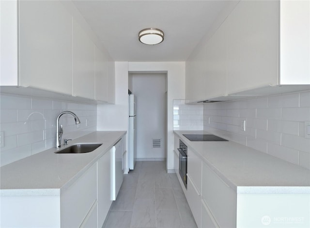 1156 Alki Ave SW Unit 204, Seattle, WA 98116 - kitchen with light countertops, a sink, white cabinetry, white appliances, and visible vents