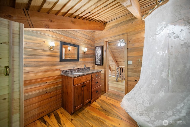 9381 Olalla Cayon Rd, Cashmere, WA 98813 - full bath featuring wood walls, vanity, wood-type flooring, beamed ceiling, and a shower