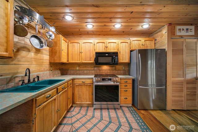 9381 Olalla Cayon Rd, Cashmere, WA 98813 - kitchen with appliances with stainless steel finishes, a sink, light countertops, wooden ceiling, and light wood finished floors