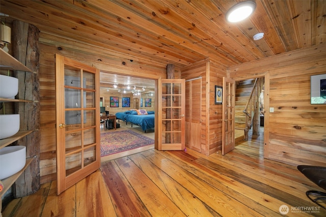 9381 Olalla Cayon Rd, Cashmere, WA 98813 - hallway with french doors, hardwood / wood-style flooring, wood walls, and wood ceiling