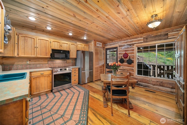 9381 Olalla Cayon Rd, Cashmere, WA 98813 - kitchen featuring stainless steel appliances, wood ceiling, light countertops, light wood-type flooring, and log walls