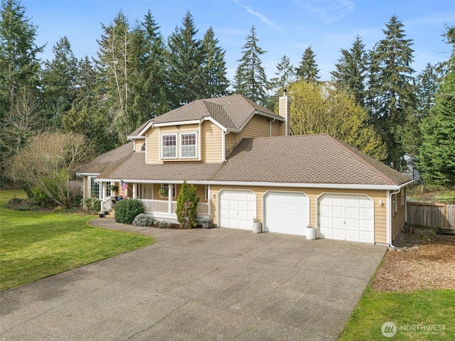 11312 134th Avenue Ct E, Puyallup, WA 98374 - traditional-style house with a chimney, driveway, a front lawn, a garage, and covered porch