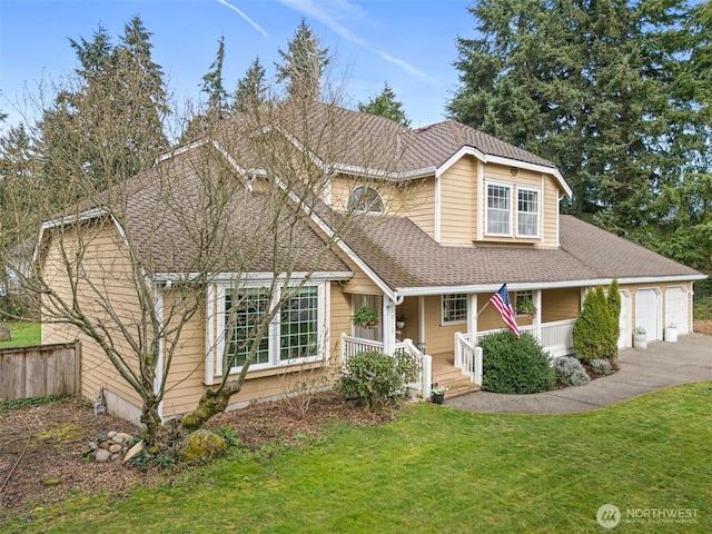 11312 134th Avenue Ct E, Puyallup, WA 98374 - traditional-style house with an attached garage, aphalt driveway, a front yard, a shingled roof, and covered porch