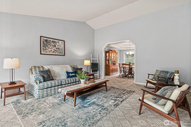 11312 134th Avenue Ct E, Puyallup, WA 98374 - living room featuring an inviting chandelier, arched walkways, baseboards, and vaulted ceiling