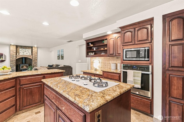 11312 134th Avenue Ct E, Puyallup, WA 98374 - kitchen featuring open floor plan, a center island, backsplash, open shelves, and stainless steel appliances
