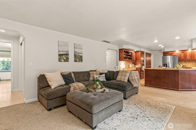 11312 134th Avenue Ct E, Puyallup, WA 98374 - living area with visible vents, baseboards, arched walkways, recessed lighting, and light colored carpet