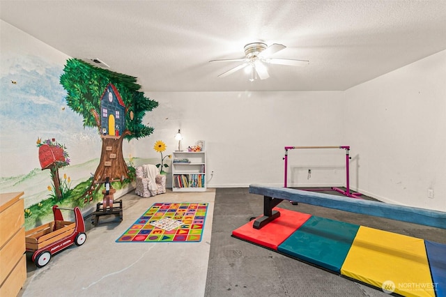 11312 134th Avenue Ct E, Puyallup, WA 98374 - game room with concrete floors, a textured ceiling, baseboards, and ceiling fan