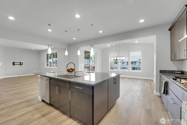 19504 141st Street Ct E, Bonney Lake, WA 98391 - kitchen with appliances with stainless steel finishes, a sink, a center island with sink, light wood finished floors, and recessed lighting