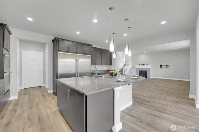 19504 141st Street Ct E, Bonney Lake, WA 98391 - kitchen featuring a sink, appliances with stainless steel finishes, light wood finished floors, baseboards, and recessed lighting