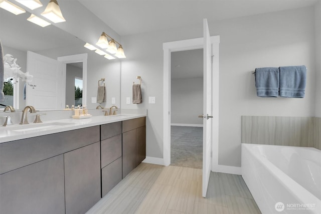 19504 141st Street Ct E, Bonney Lake, WA 98391 - bathroom featuring double vanity, a bath, and baseboards