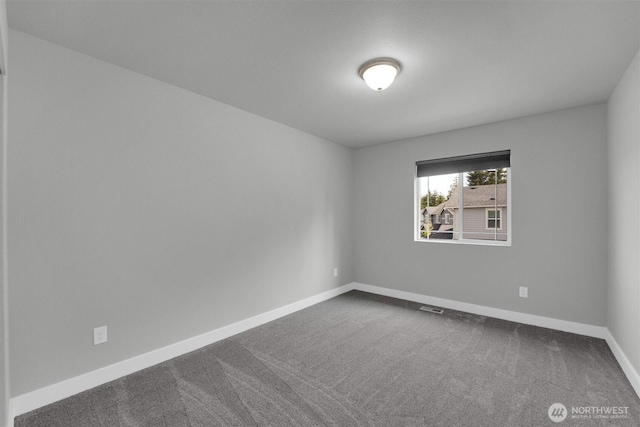 19504 141st Street Ct E, Bonney Lake, WA 98391 - spare room featuring baseboards and dark colored carpet