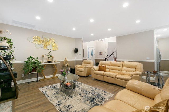 living area featuring crown molding, recessed lighting, and wood finished floors