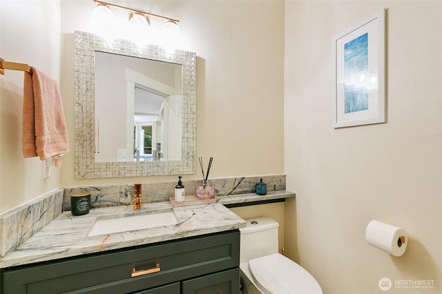 bathroom with vanity and toilet