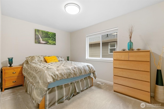 bedroom with carpet floors, baseboards, and visible vents