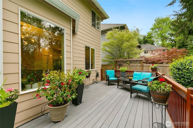 wooden deck featuring fence and an outdoor living space