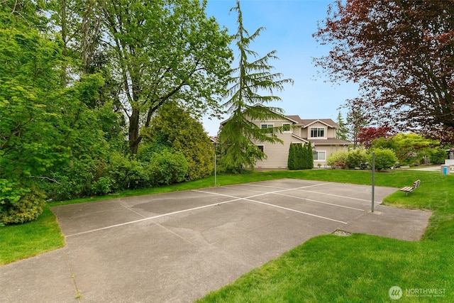 view of sport court featuring a yard