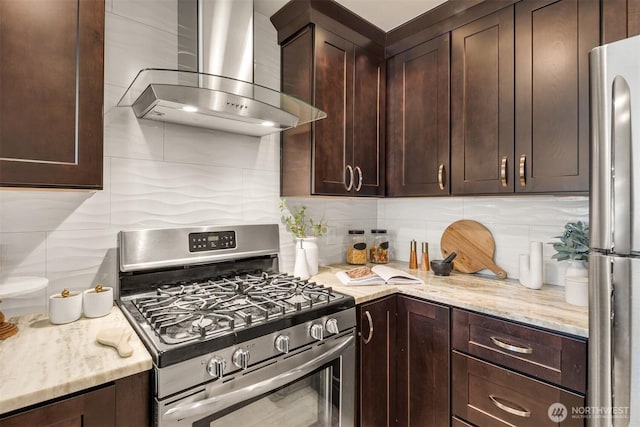 10047 Main St Unit 305, Bellevue, WA 98004 - kitchen featuring stainless steel appliances, wall chimney range hood, dark brown cabinetry, backsplash, and light stone counters
