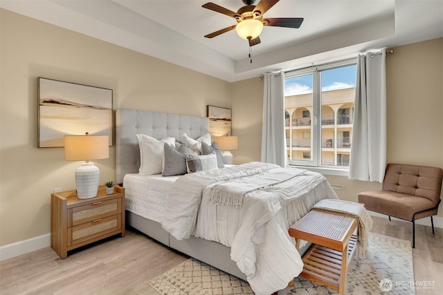 10047 Main St Unit 305, Bellevue, WA 98004 - bedroom with light wood-style floors, baseboards, and a ceiling fan