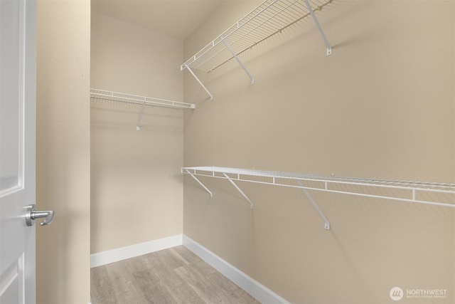 10047 Main St Unit 305, Bellevue, WA 98004 - walk in closet featuring wood finished floors