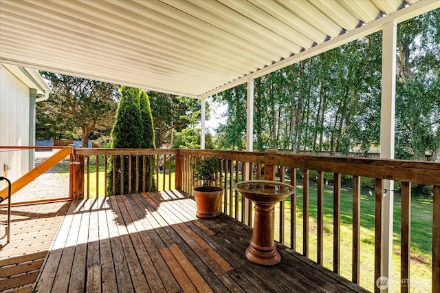 wooden terrace with a lawn