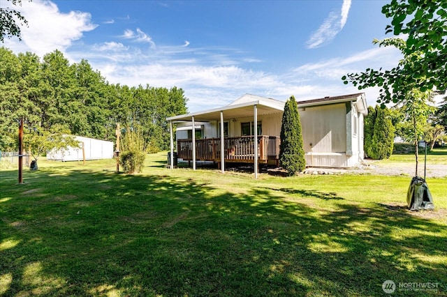 back of property featuring a lawn and a deck