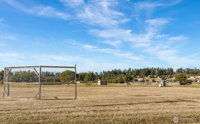 surrounding community with a lawn, fence, an outbuilding, and a storage unit