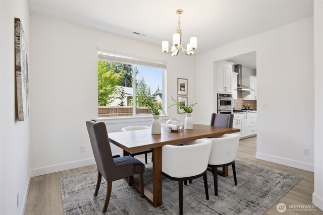 5842 229th Ave E, Buckley, WA 98321 - dining room featuring a chandelier and light wood-style flooring