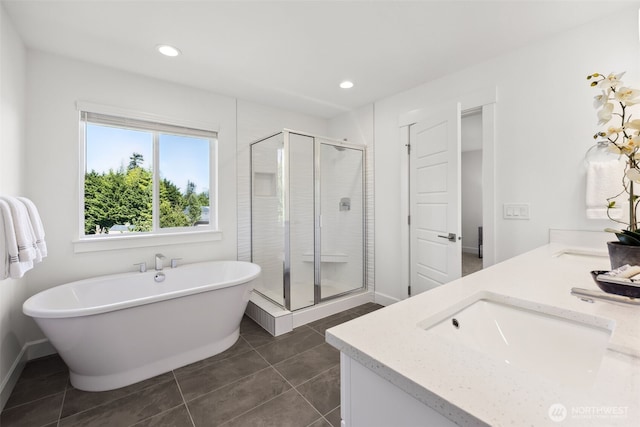 5842 229th Ave E, Buckley, WA 98321 - full bathroom featuring double vanity, a shower stall, a soaking tub, recessed lighting, and tile patterned flooring