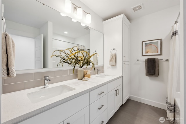 5842 229th Ave E, Buckley, WA 98321 - full bath featuring double vanity, tasteful backsplash, wood finished floors, a shower with curtain, and recessed lighting