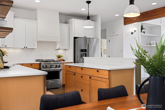 kitchen featuring light countertops, tasteful backsplash, recessed lighting, and high quality appliances