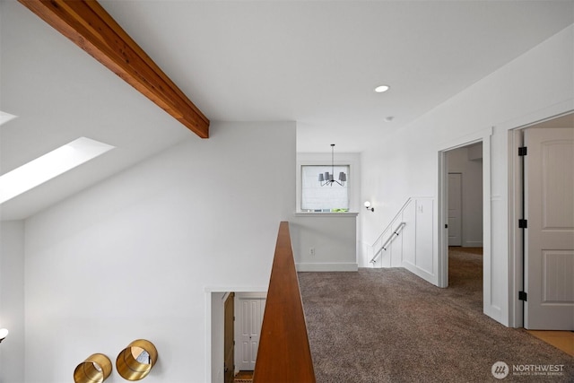 hall with recessed lighting, carpet, baseboards, lofted ceiling with skylight, and an upstairs landing