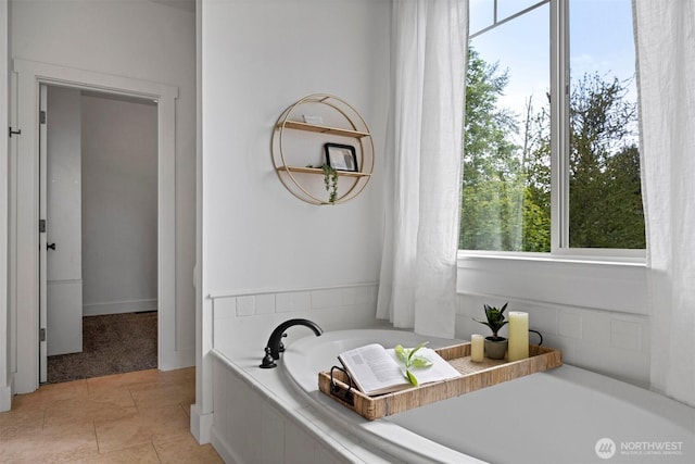 bathroom featuring tile patterned flooring and a bath