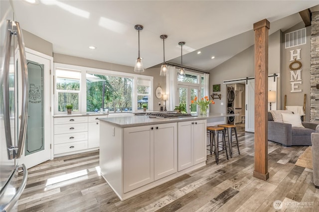 16005 SE Lake Holm Rd, Auburn, WA 98092 - kitchen featuring light countertops, appliances with stainless steel finishes, a barn door, white cabinetry, and light wood-type flooring