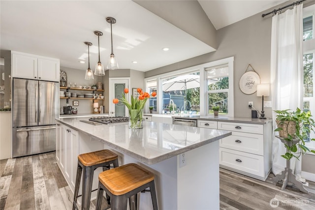 16005 SE Lake Holm Rd, Auburn, WA 98092 - kitchen featuring a healthy amount of sunlight, white cabinetry, light wood-style flooring, and stainless steel appliances